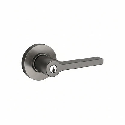 A modern lever door handle with a matte dark gray finish, featuring a round satin-brushed backplate and a keyhole with a black center insert, shown on a plain white background.